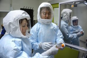 Research technicians Jill Van Kessel and Ze Lim working in VIDO-InterVac’s containment level 3 facility. Photo USask - Gord Waldner